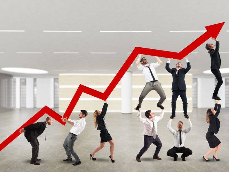 45729722 - businessperson working together to raise an arrow