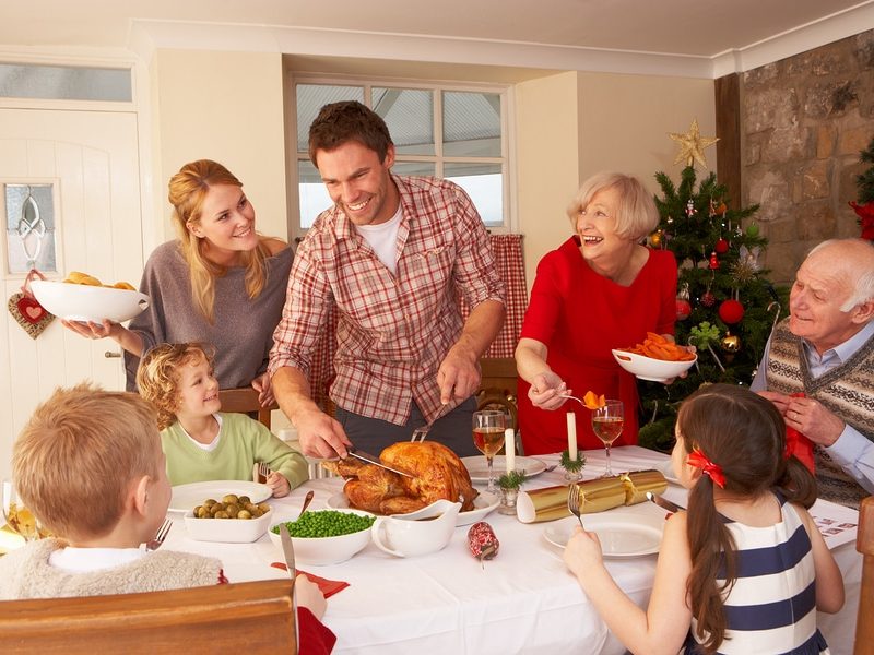 Family serving Christmas dinner